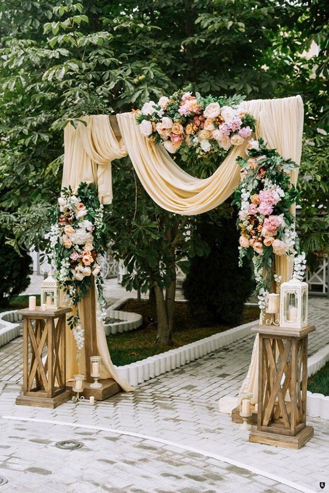 an outdoor ceremony with flowers and candles