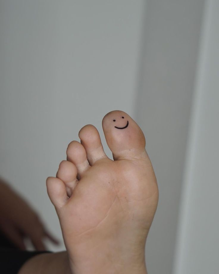 a close up of a person's foot with a smiley face on it