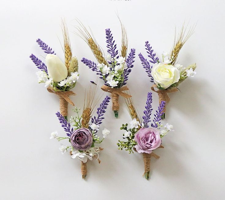 three bouquets of flowers are arranged on the wall