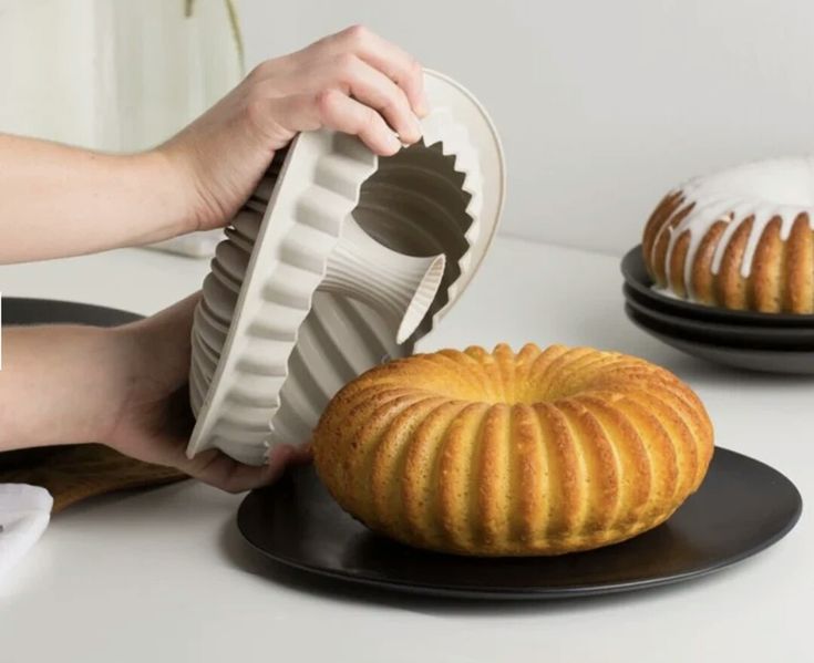 a bundt cake being made by someone holding the bundt cake in their hand