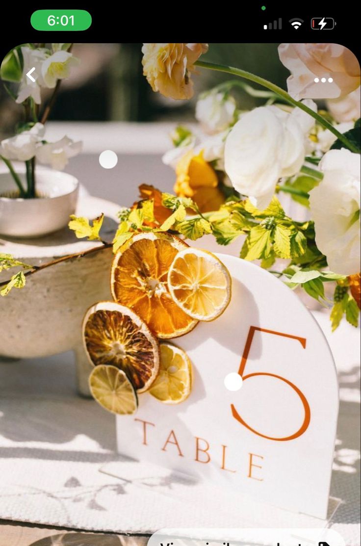 the table numbers are displayed with oranges and flowers