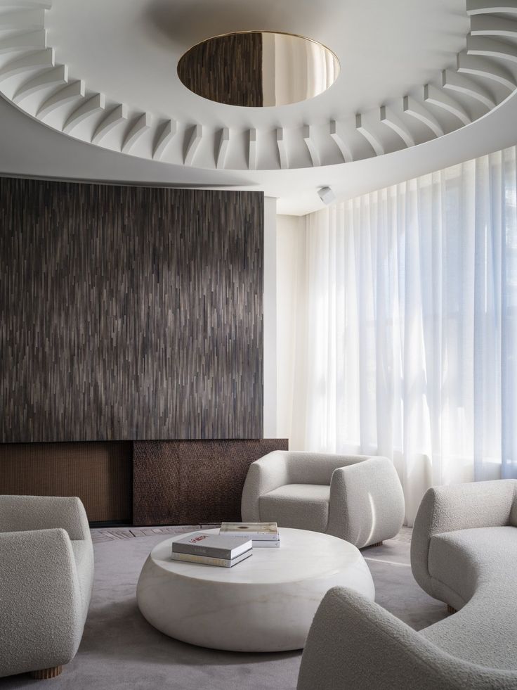 a living room filled with white furniture next to a window