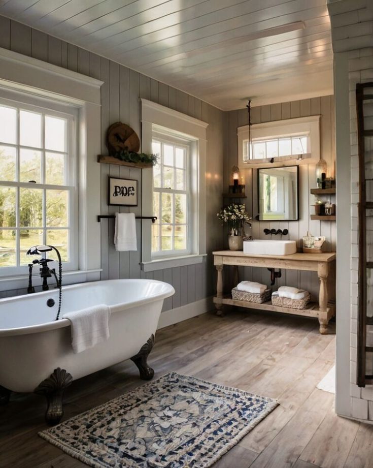 a bathroom with a claw foot tub and wooden floors