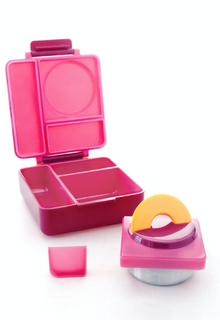 a pink lunch box with two compartments and an orange lid next to it on a white surface