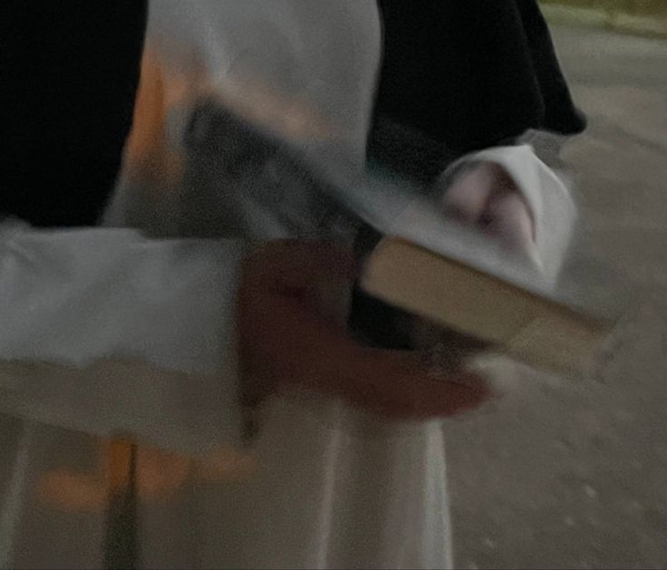 a blurry image of a person holding a book