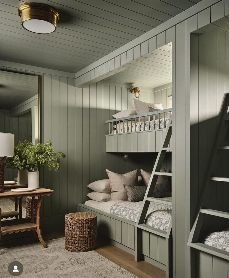 a bunk bed in a room with green walls