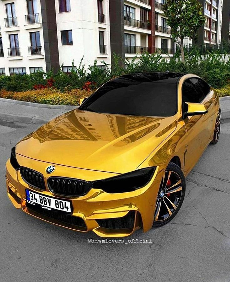 a yellow car is parked in front of some buildings