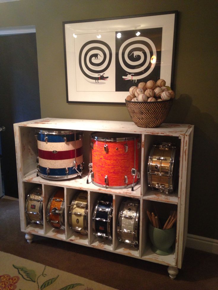 a drum set sitting on top of a wooden shelf