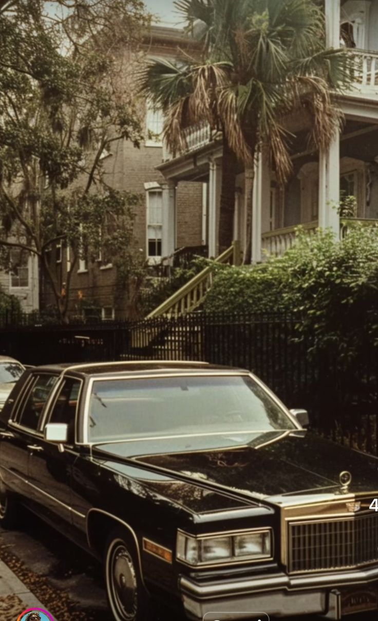 a black car parked in front of a house