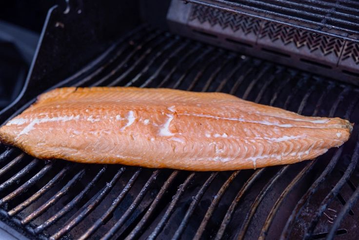 the fish is being cooked on the grill