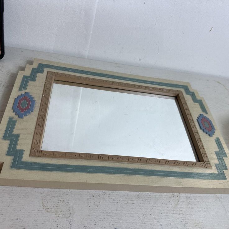 a mirror sitting on top of a white table