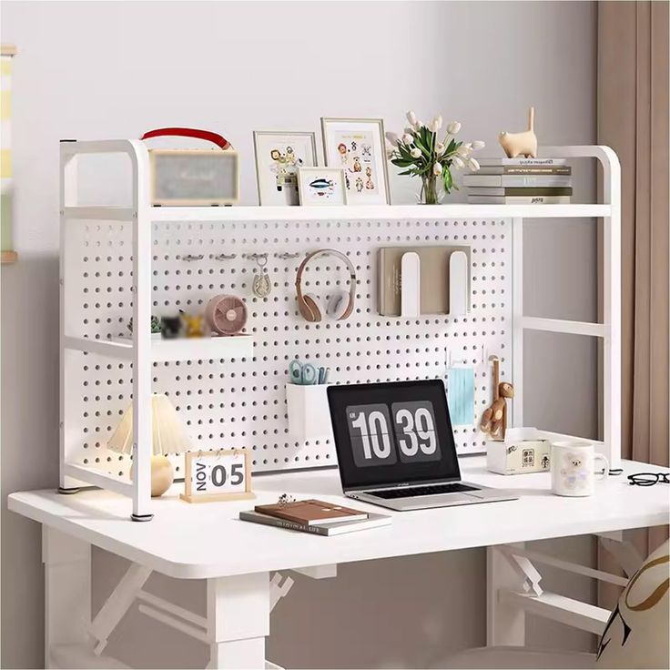 a laptop computer sitting on top of a white desk