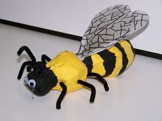 a paper mache bee sitting on top of a table