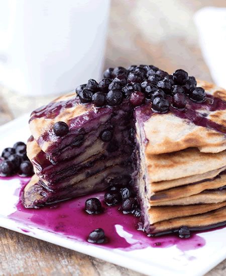 a stack of pancakes with blueberries on top