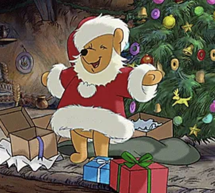 a cartoon bear dressed as santa clause sitting next to a christmas tree