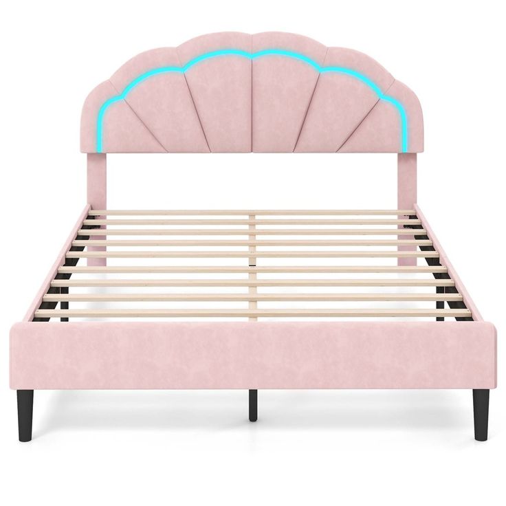 a pink bed frame with an arch shaped headboard and foot board, in front of a white background