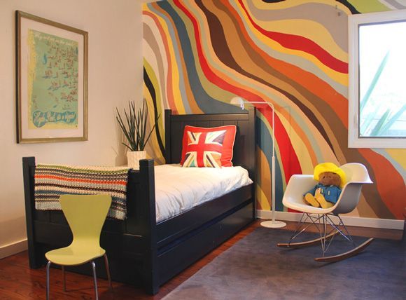 an image of a bedroom with colorful wallpaper on the walls and furniture in the room