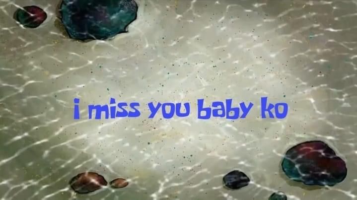 the words i miss you baby ko written in blue ink on an image of sea shells