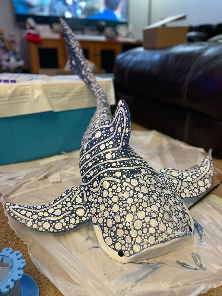 a paper mache of a fish sitting on top of plastic