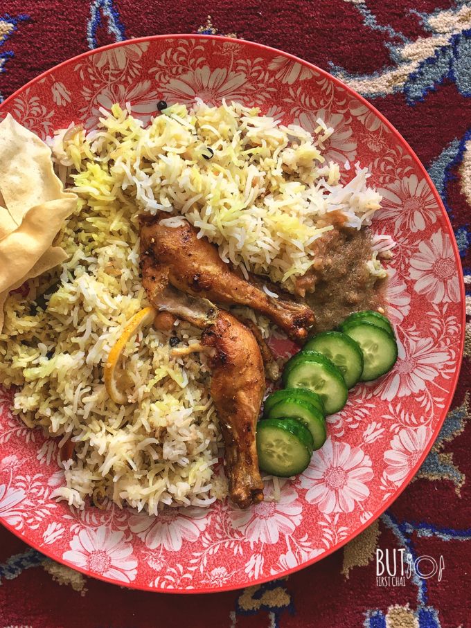 a red plate topped with rice and cucumbers