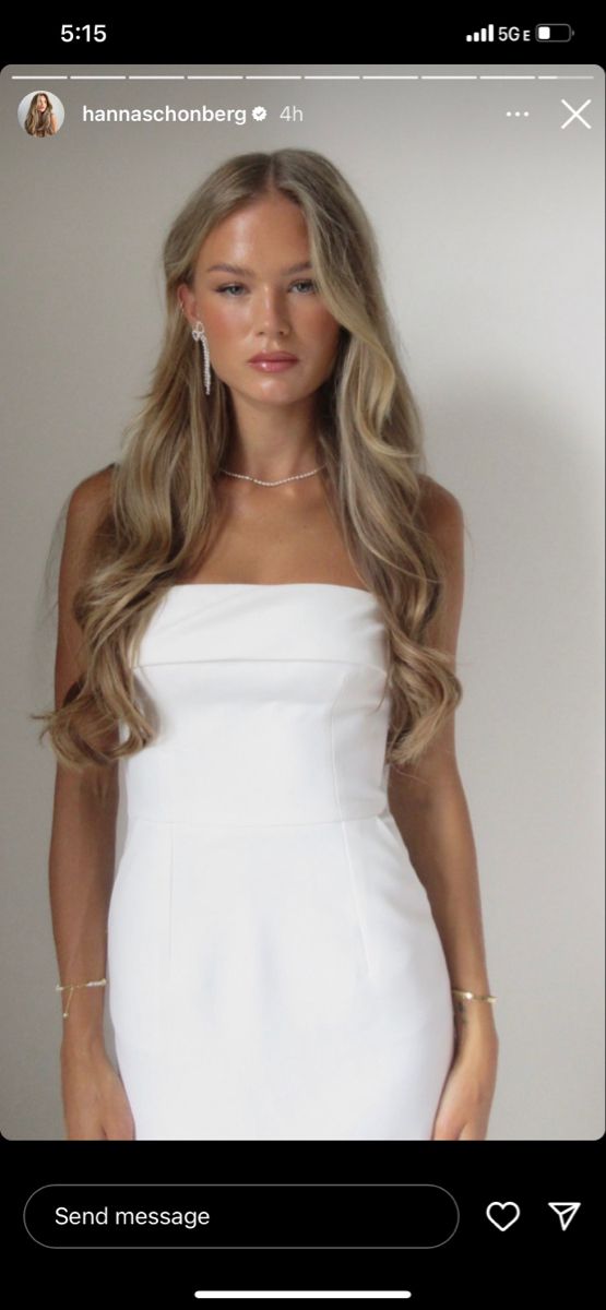 a woman with long hair wearing a white dress