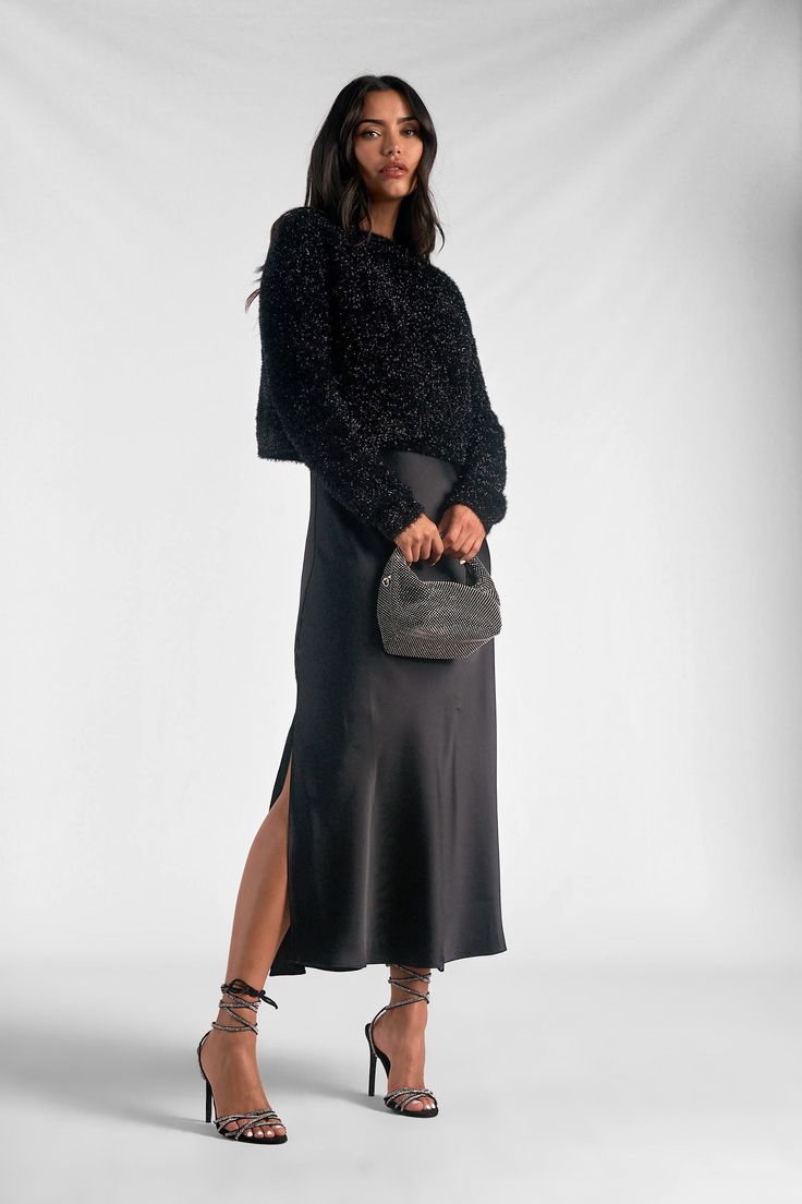 Say hello to the "Renzo" set - where comfort meets sophistication. The fuzzy sweater with its subtle shiny details exudes casual elegance. Paired with a metallic silky maxi skirt, it strikes a perfect balance between modesty and high fashion. Renzo is crafted for the modern woman seeking both style and comfort in one effortlessly chic ensemble. Elevate your wardrobe with this versatile blend of cozy and glamorous - because looking fabulous should always feel this good. Elegant Slip Dress Outfit, Sweater And Slip Dress, Black Dress With Sweater Over It, Sweater Over Slip Dress, Layered Slip Dress Outfit, Slip Dress And Sweater, Sweater And Dress Layering, Slip Dress With Sweater, Dress With Sweater Over It