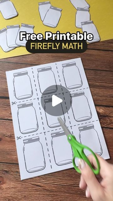 a person cutting out a printable firefly math game