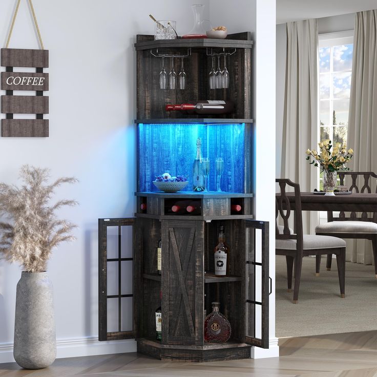 an entertainment center in the corner of a living room with a blue light on it