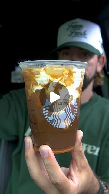 a man holding up a cup of coffee