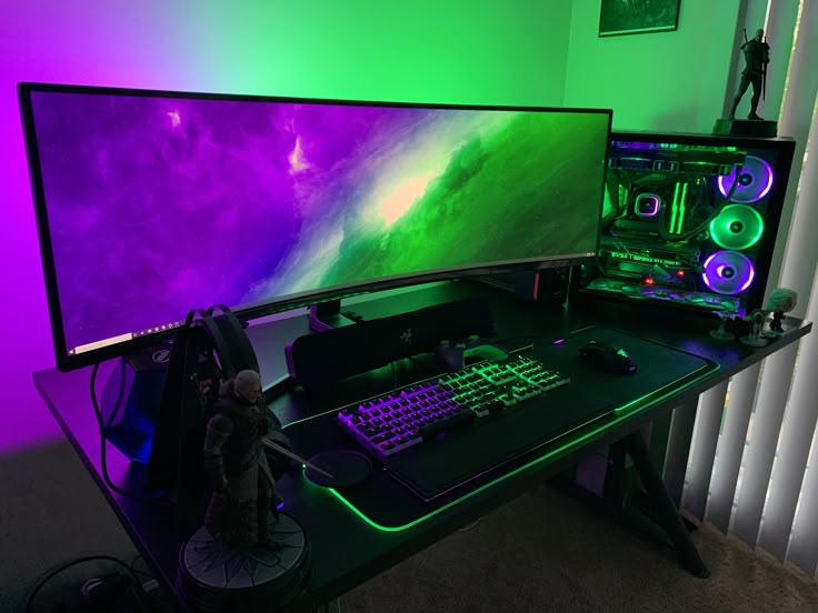 a computer desk with two monitors and a keyboard in front of a purple and green wall