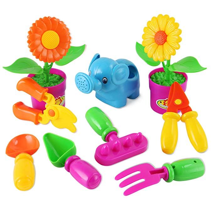 a bunch of toys that are in a flower pot and some gardening utensils