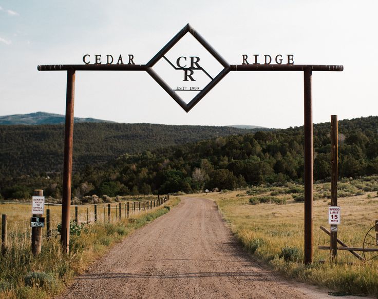 a dirt road with a sign that says cedar ridge