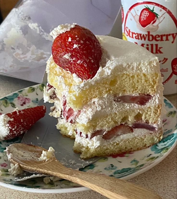 a piece of cake on a plate with strawberries