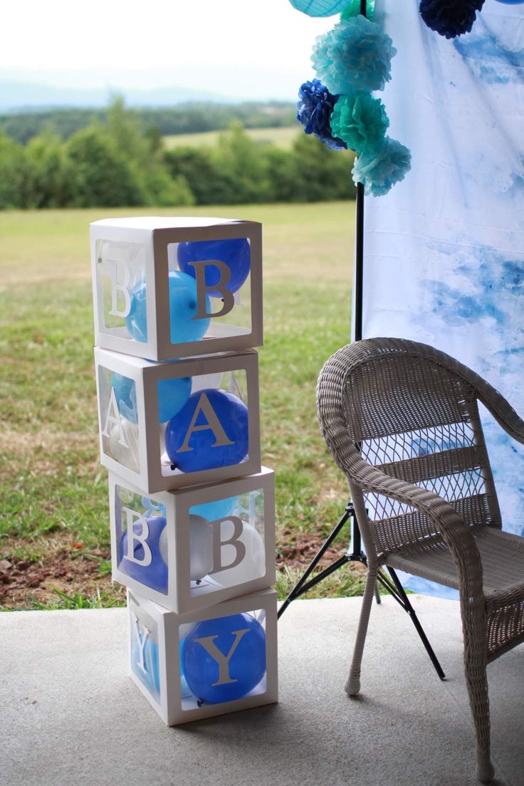 a chair sitting next to a stack of blocks that spell out the word abc and y