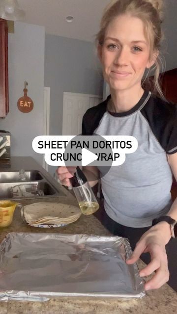 a woman standing in front of a pan filled with food