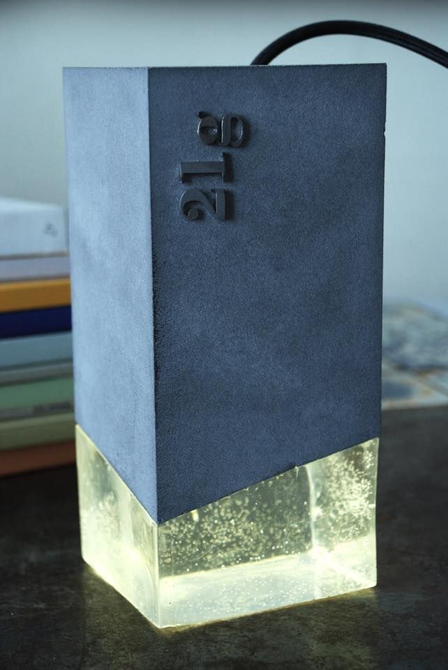 a black and white vase sitting on top of a table next to a pile of books