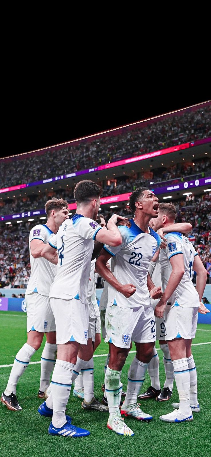 a group of men standing on top of a soccer field