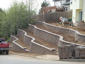 a truck is parked in front of a retaining wall