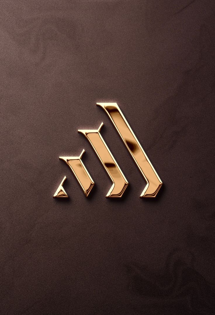 the letter m is made out of gold metal and has an arrow shaped design on it