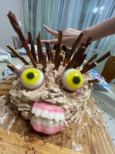 a cake with sticks sticking out of it's face