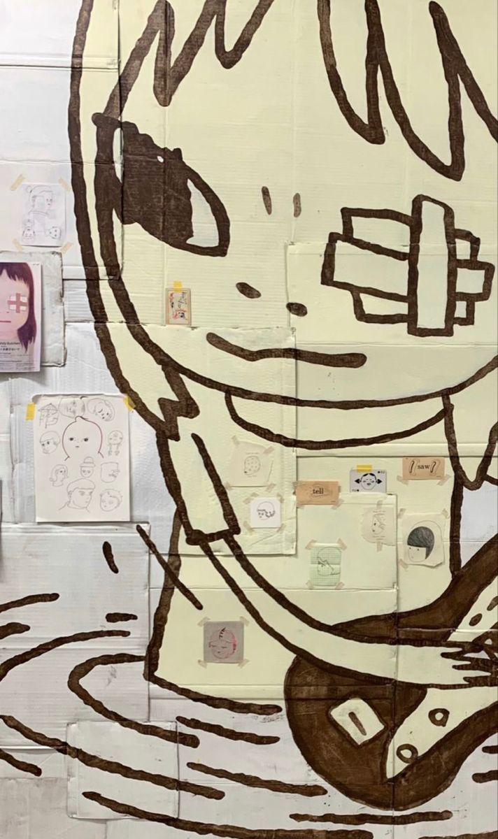 a child's drawing is shown on the side of a wall with many pictures around it