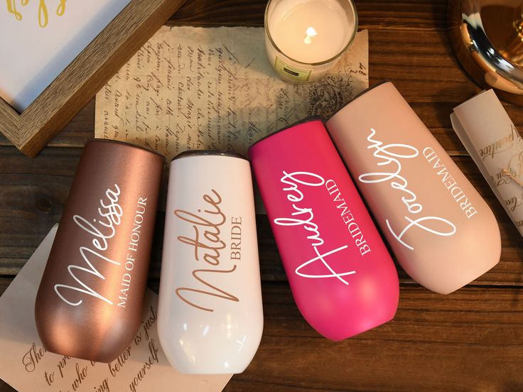 three personalized coffee mugs sitting on top of a table next to a candle