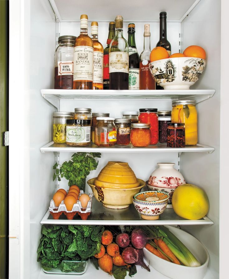 an open refrigerator filled with lots of food and condiments in it's shelves