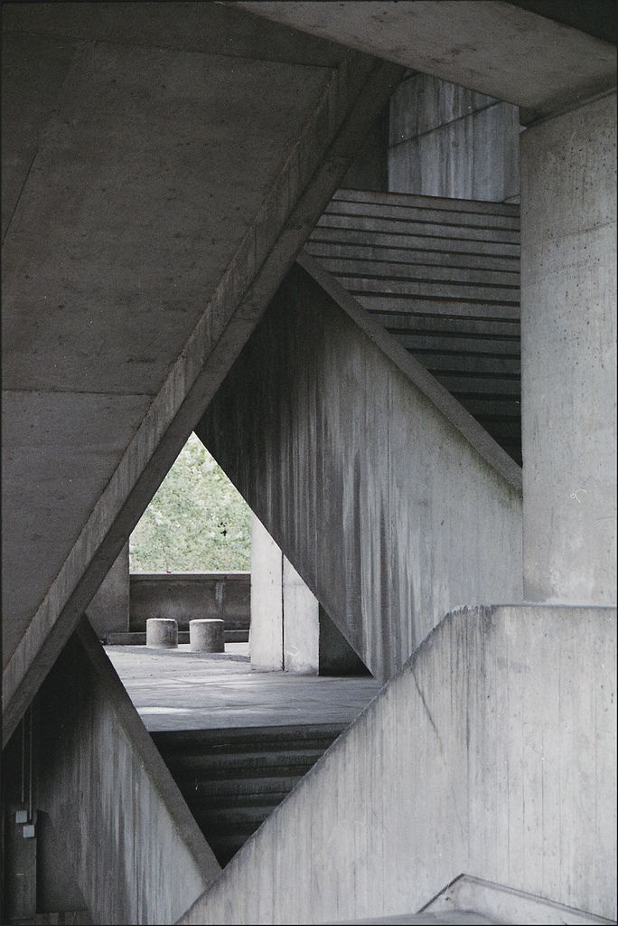 an abstract photo of concrete structures with stairs leading up to the top and bottom floor