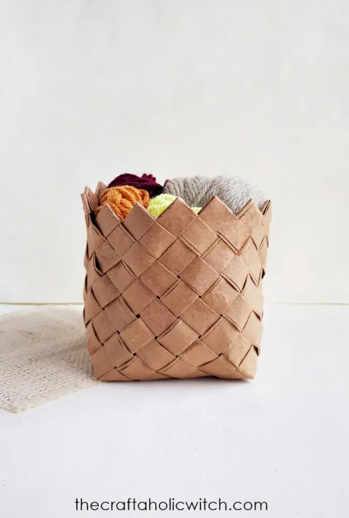 a basket filled with fruit and vegetables sitting on top of a white tablecloth covered floor