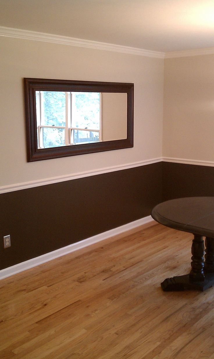 an empty room with hard wood floors and a round table in the middle, near a window