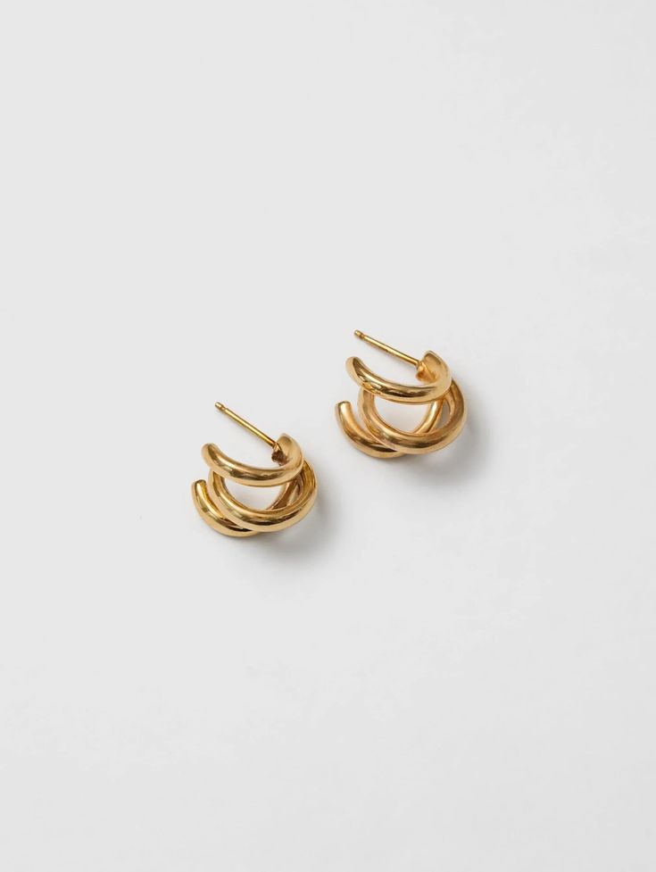 TRIPLE TROUBLE WHAT IT IS: A small triple hoop earring WHY IT’S SPECIAL: The triple hoop design is an eye catching but clean style, that's easy to wear Handcrafted jewelry that carries a sense of individuality and attention to detail GOOD TO KNOW: 14k Gold plated bronze 14k Gold vermeil posts 15mm in diameter Sold as a pair WHY WE LOVE WOLF CIRCUS: This line of demi-fine jewelry is crafted by hand in Vancouver, BC using a hand fabricated technique or the intricate lost-wax process. They offer luxe designs we love without sacrificing a commitment to sustainability as recycled sterling silver or bronze are incorporated into each piece before being coating in 14K gold. Triple Hoop Earrings, Demi Fine Jewelry, Charm Rings, Small Heart, Vancouver Bc, Recycled Sterling Silver, Earrings Collection, Gold Earrings Studs, Gold Studs