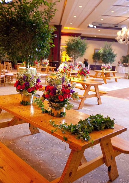 the tables are set up with flowers and greenery