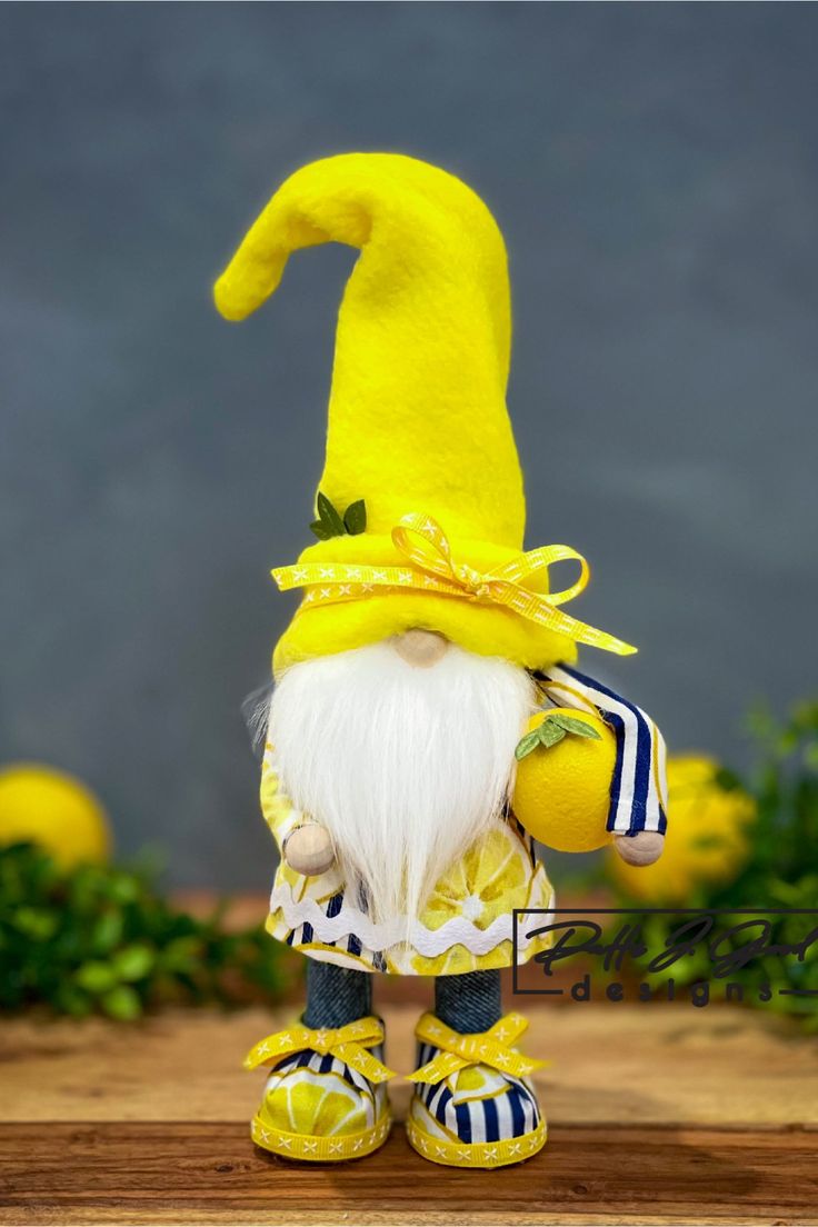 a yellow and white gnome figurine on a wooden table