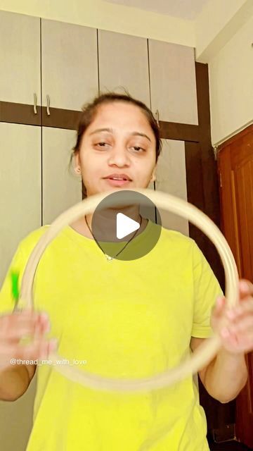 a woman holding a hula hoop in her hands